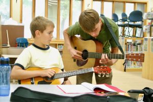 Guitar teacher and student