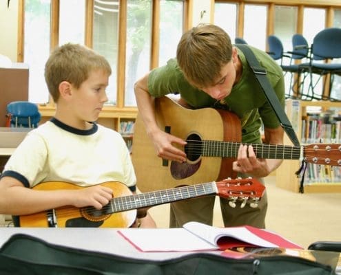Guitar teacher and student