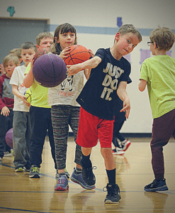 Basketball kids in line to practice their basketball drills.