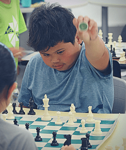 YEL chess student prepares to capture the piece from his opponent.