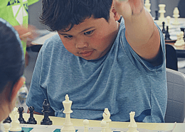 YEL chess student prepares to capture the piece from his opponent.