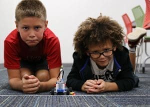 Two Brick Builder students prepare to race their car made out of LEGO Bricks.