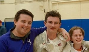 Coach Murphy has his arm around one of his fencers.