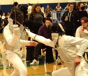 Fencer on the right hitting fencer on the left with an excellent attack on the shoulder.